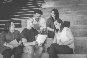 Five adult learners sitting in a lecture hall group learning