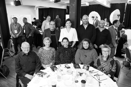 People at table smiling bw