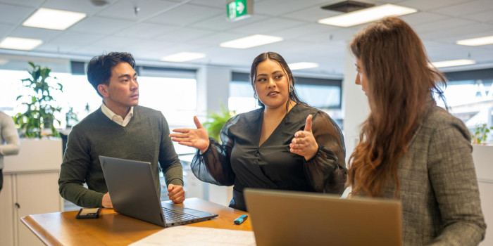 Three people at an office table