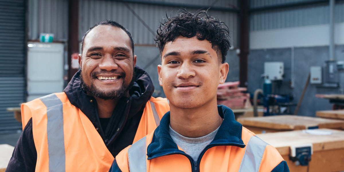 Two people smiling wearing hi vis gear